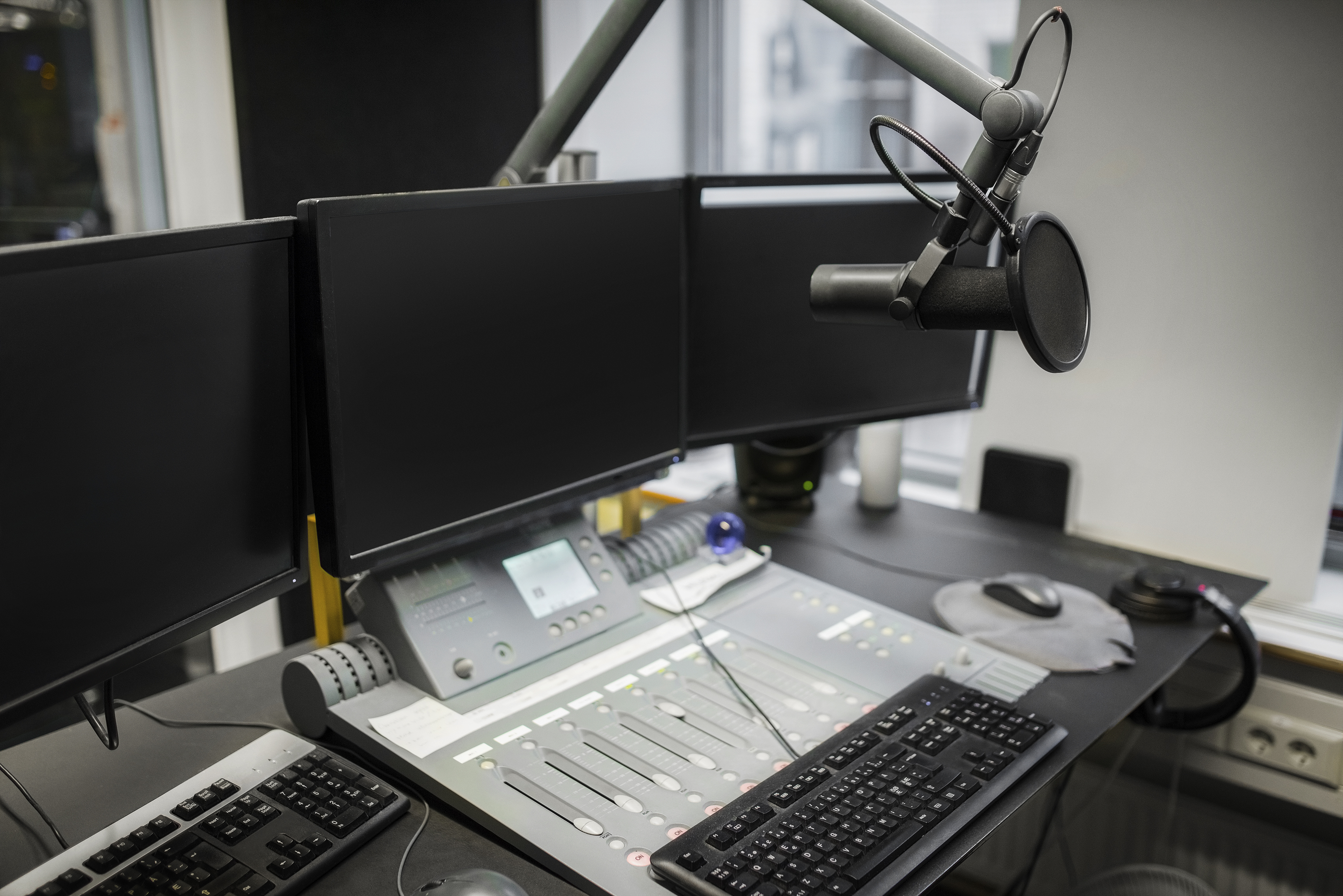 graphicstock-monitors-and-microphone-over-table-in-radio-studio_B7ovyO8L-.jpg